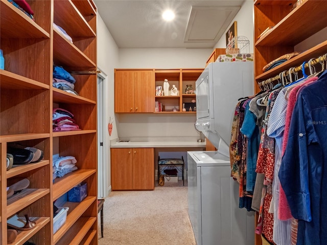 laundry room with light carpet and stacked washer / drying machine