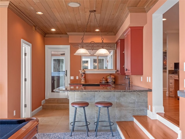 kitchen featuring pendant lighting, dark stone countertops, light tile patterned floors, ornamental molding, and pool table