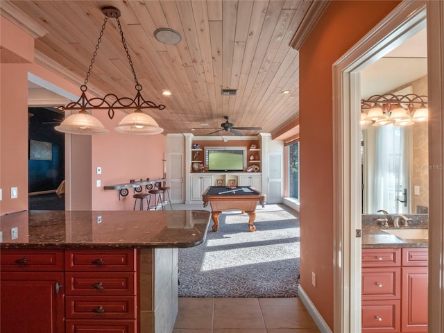 kitchen with dark stone counters, hanging light fixtures, ceiling fan, pool table, and wood ceiling