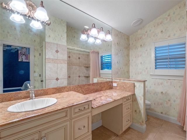 bathroom featuring toilet, vanity, tile patterned floors, and curtained shower