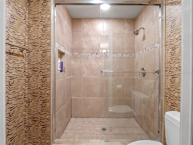 bathroom with tiled shower and toilet