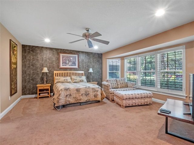 carpeted bedroom with multiple windows and ceiling fan