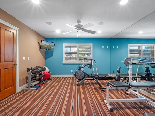 exercise area featuring carpet flooring and ceiling fan