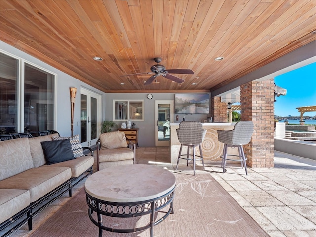 view of patio / terrace with ceiling fan, an outdoor bar, and an outdoor hangout area