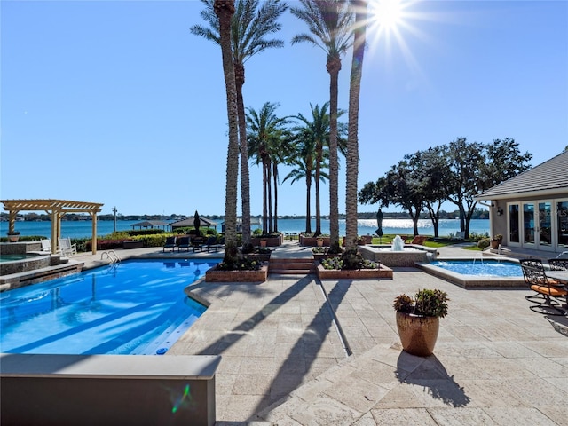 view of swimming pool with a pergola, a water view, a hot tub, and a patio area