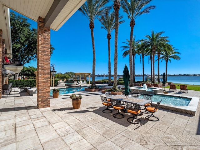 view of patio featuring pool water feature and a water view