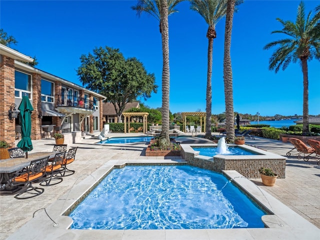 view of pool with a pergola and pool water feature