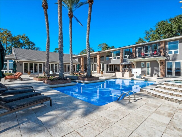 view of pool featuring a patio and area for grilling