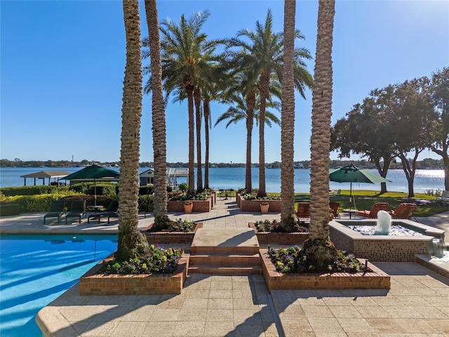 exterior space with a water view and a patio area