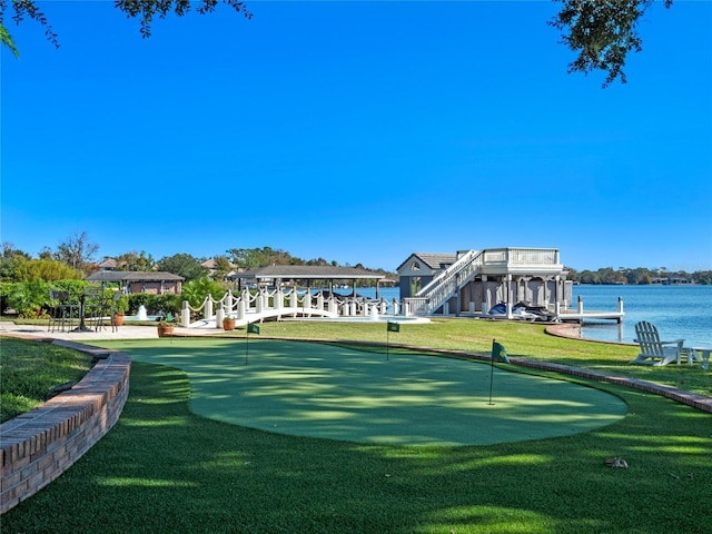 view of property's community featuring a water view and a yard