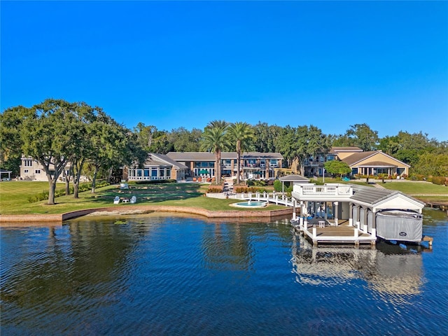 rear view of house featuring a yard and a water view