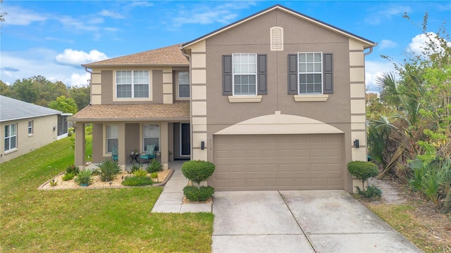 view of front of home with a garage and a front lawn