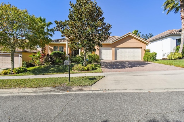 view of front of house with a front lawn and a garage