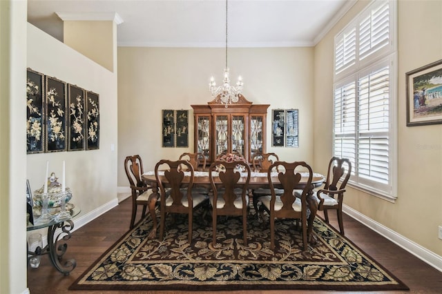 dining space with crown molding, dark hardwood / wood-style flooring, and a notable chandelier