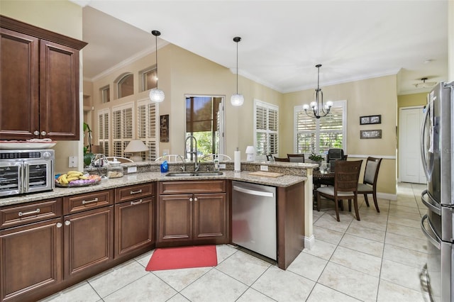 kitchen featuring sink, a notable chandelier, light stone counters, kitchen peninsula, and stainless steel appliances