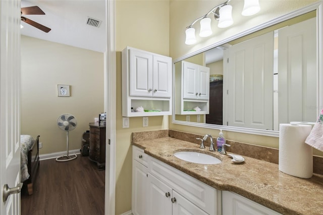 bathroom featuring ceiling fan, hardwood / wood-style floors, and vanity