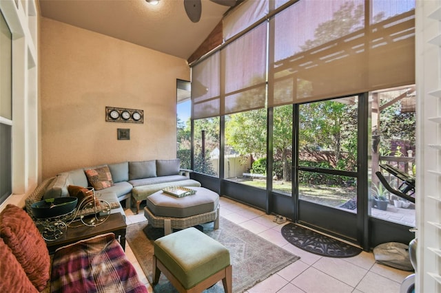 sunroom / solarium featuring ceiling fan, a healthy amount of sunlight, and lofted ceiling