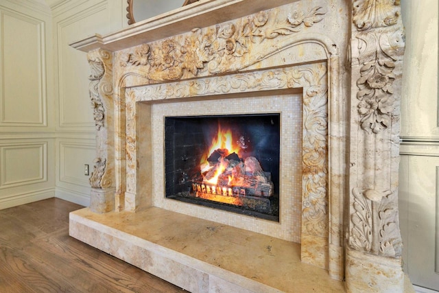 interior details featuring hardwood / wood-style flooring and a premium fireplace