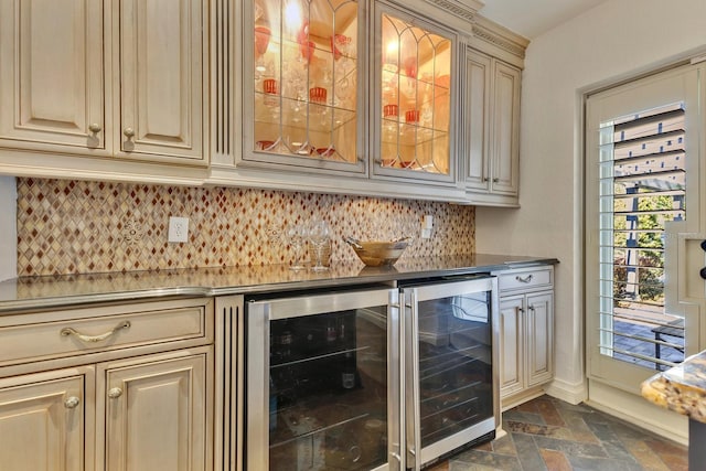 bar featuring cream cabinetry, beverage cooler, and backsplash