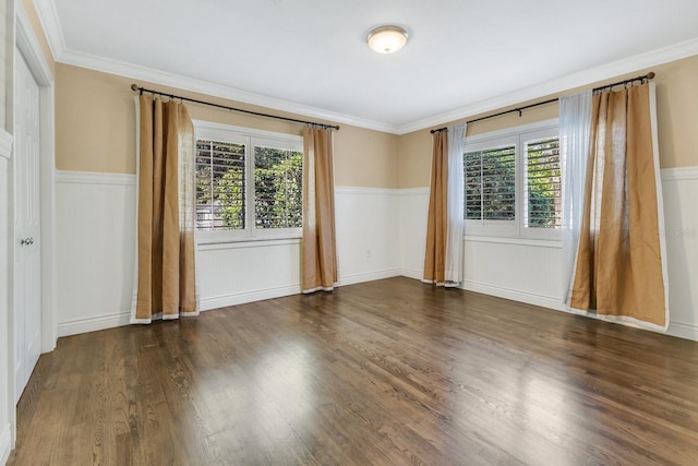 empty room with plenty of natural light, dark hardwood / wood-style flooring, and crown molding