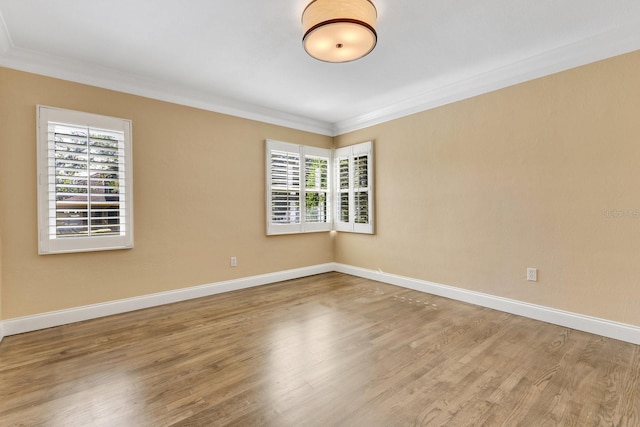 unfurnished room with hardwood / wood-style floors and ornamental molding