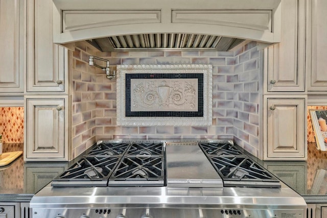 interior details with stove, custom exhaust hood, and cream cabinets