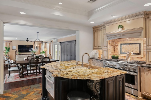 kitchen featuring an island with sink, stainless steel appliances, light stone countertops, crown molding, and sink