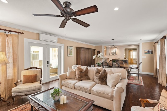 living room with ceiling fan, dark hardwood / wood-style flooring, french doors, crown molding, and an AC wall unit