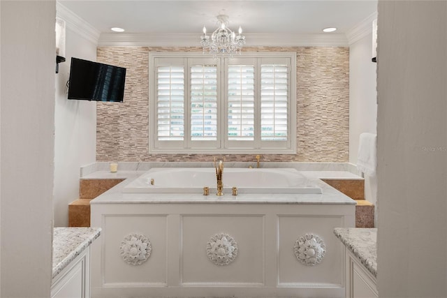 bathroom featuring a tub, vanity, crown molding, and an inviting chandelier