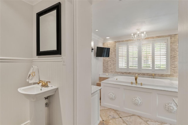 bathroom featuring a chandelier, sink, ornamental molding, and a bath