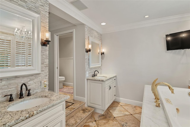 bathroom with toilet, vanity, and crown molding