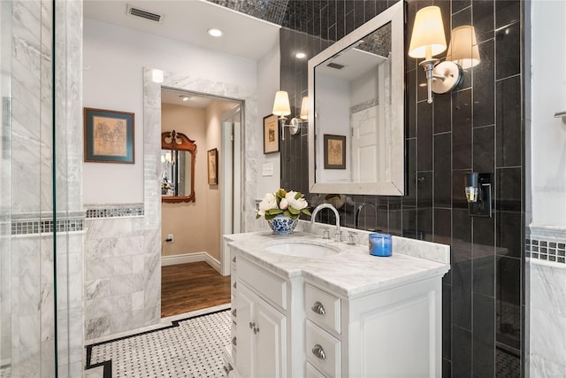 bathroom featuring vanity, tile patterned floors, and a shower with door