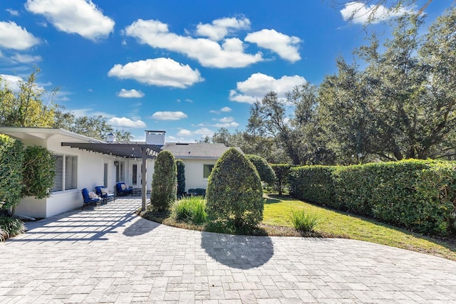 view of front facade featuring a front yard and a patio