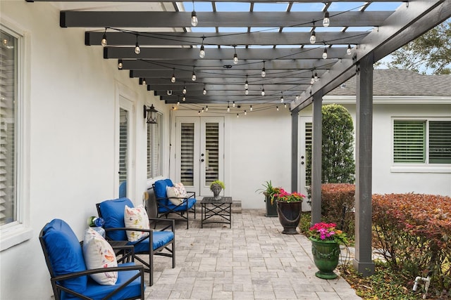 view of patio featuring a pergola, outdoor lounge area, and french doors