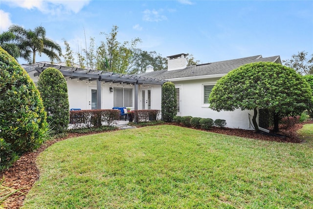 view of front of house with a pergola and a front lawn