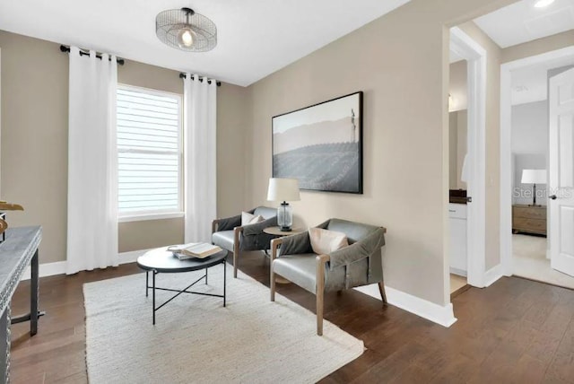 sitting room with dark hardwood / wood-style flooring and a healthy amount of sunlight