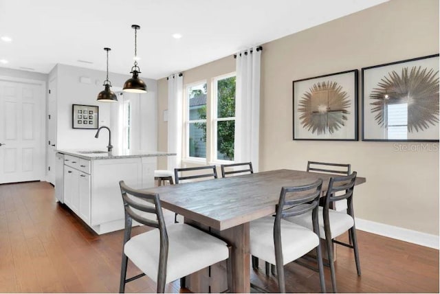 dining area with sink and dark hardwood / wood-style floors