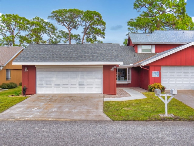 view of front of property with a garage and a front lawn