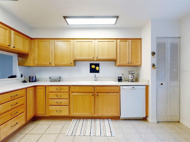 kitchen featuring dishwasher, light tile patterned floors, and sink