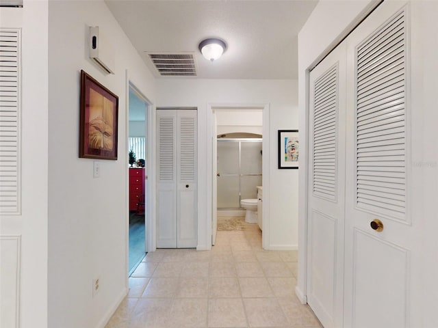 corridor featuring light tile patterned floors