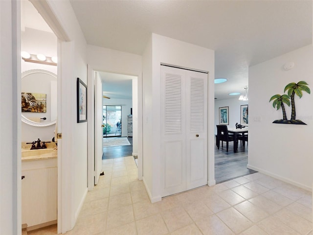 hallway featuring sink and light hardwood / wood-style floors