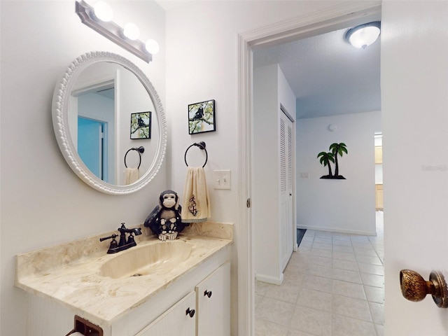 bathroom with tile patterned flooring and vanity