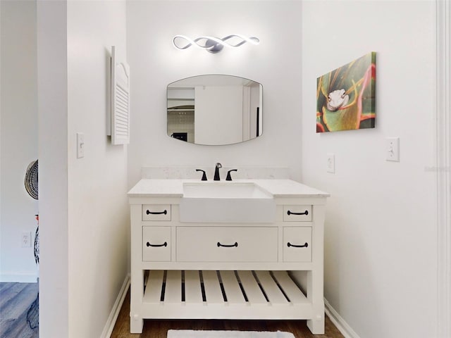 bathroom with vanity and hardwood / wood-style flooring