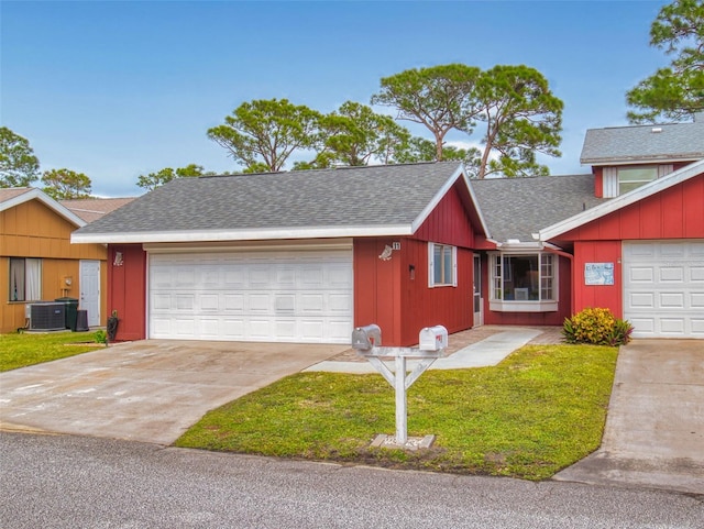 view of front of home featuring a garage, central air condition unit, and a front lawn