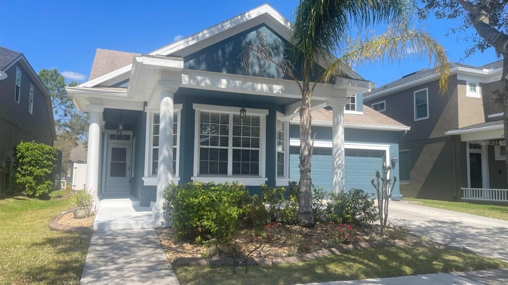 view of front facade with a garage, concrete driveway, and stucco siding