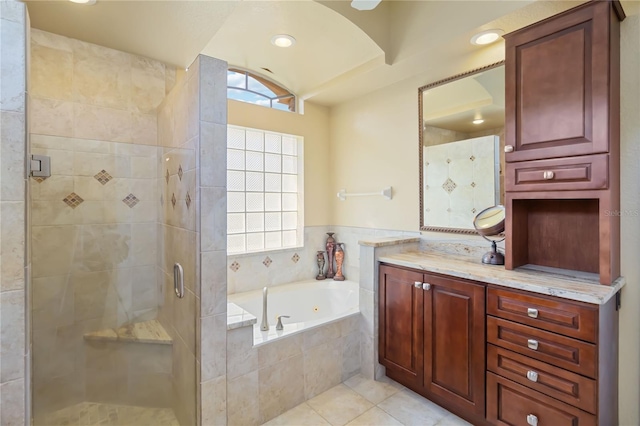 bathroom featuring tile patterned flooring, vanity, and plus walk in shower