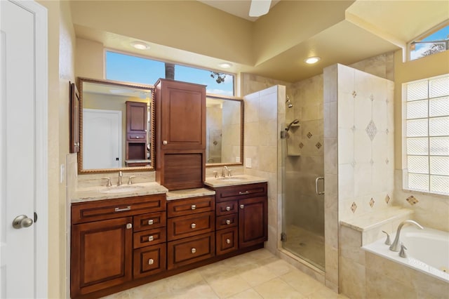 bathroom with tile patterned flooring, vanity, plus walk in shower, and a wealth of natural light