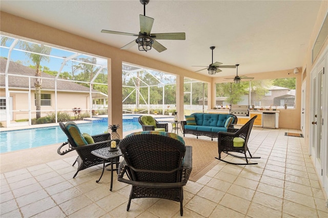 sunroom featuring ceiling fan and a pool