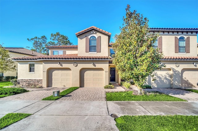 8169 Roseville Rd, Davenport, FL 33896 - mediterranean / spanish-style home with driveway, stucco siding, a tile roof, and an attached garage