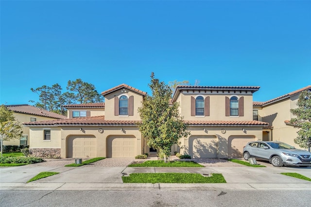 mediterranean / spanish home featuring a garage